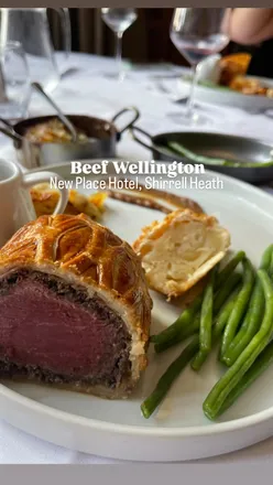 Tableside Beef Wellington with dauphinoise, caramelized shallot purée, and green beans at New Place Hotel.