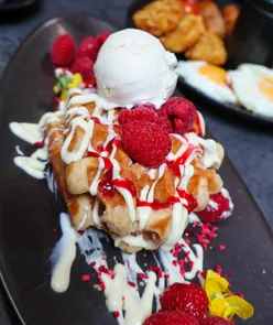 Delicious white chocolate and raspberry waffle stack at The Bloom and Brew in Wakefield, perfect for breakfast lovers.