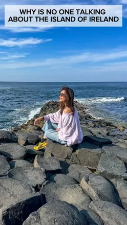 Traveler exploring the scenic Causeway Coastal Route, with picturesque views and historic castles along the way.