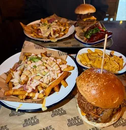 Delicious Filthy Pig Burger and Crispy Bacon Dirty Fries at Bare Grills, Bristol, known for smoky BBQ flavors.