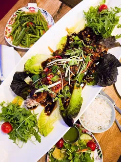 Sea bass sharer at Aberdeen Seafood on King's Road, Brighton, showcasing vibrant seafood in a lively atmosphere.