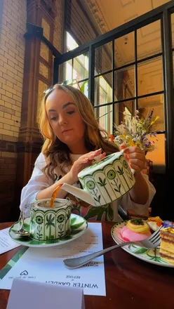 Elegant afternoon tea at The Refuge in Manchester, featuring bespoke teas and exquisite treats in a historic setting.