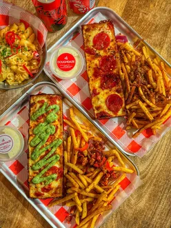 Newcastle near St James's Stadium: pizza collab by WeAreDoughDaze & TheDispenaryNC—pepperoni slices, loaded fries.