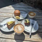 Enjoying a delicious coffee and cake spread at Baern Cafe in East Neuk, Fife, featuring flat whites and gourmet pastries.