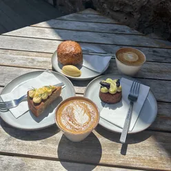 Enjoying a delicious coffee and cake spread at Baern Cafe in East Neuk, Fife, featuring flat whites and gourmet pastries.
