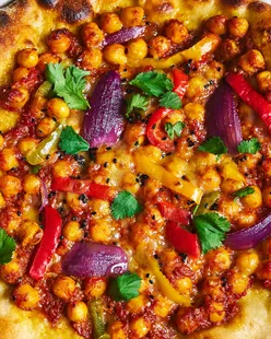 Creative curry masala pizza with chickpeas, peppers, and onions, ready in under 20 minutes.