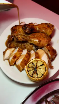 Tender charred peri chicken with lemon and gravy at The Firehouse, Manchester's must-try supper club menu.