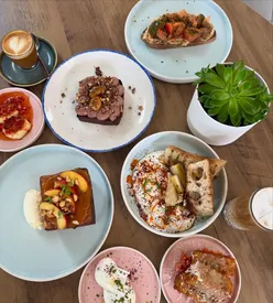 Brunch spread at Friends of Ours in Hyde Park featuring peach jam French toast, banana bread, and hash browns.