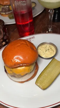 Delicious gourmet burger at Glasgow Kelvin Grove Cafe, praised as the best in the city by a satisfied food lover.