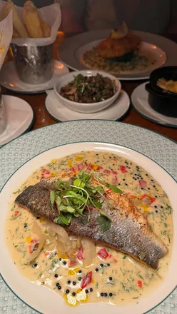 Enjoying a cozy evening at Cosy Club Leeds with cocktails and a delicious variety of dishes in a beautifully renovated space.