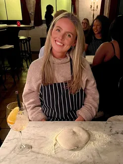 Guests enjoying Neapolitan pizzas at Well Street Pizza launch event in London Fields Pub, with vibrant atmosphere.