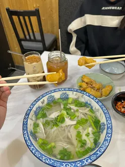 Delicious Vietnamese dishes at Pho Cue Kitchen in Manchester's China Town, featuring chicken pho and salt & pepper bites.