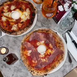 Enjoying a delicious pizza and cocktails at Zia Lucia in London, the perfect spot for pizza lovers.