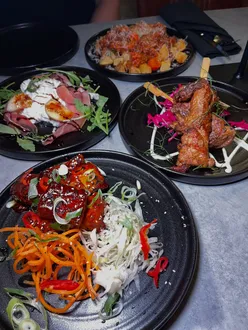 Delicious tapas at The Cove in Tynemouth: Patatas bravas, chicken shawarma, belly pork, and burrata with peaches.