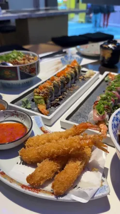 Highyaki's delicious lunch menu featuring dragon rolls, dumplings, and teriyaki chicken donburi in a chic Chinatown setting.