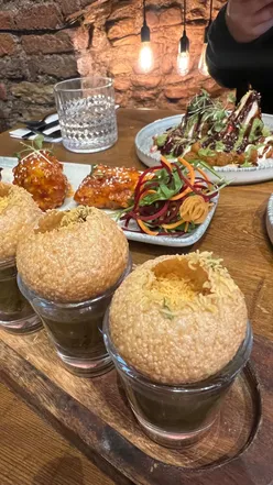 Delicious Indian dishes enjoyed at Black Cumin in Bristol, featuring gol gappa, Padina lamb, and biryani.