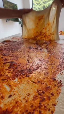 Delicious sourdough bread with rose harissa and roasted garlic for a flavorful home baking experience.