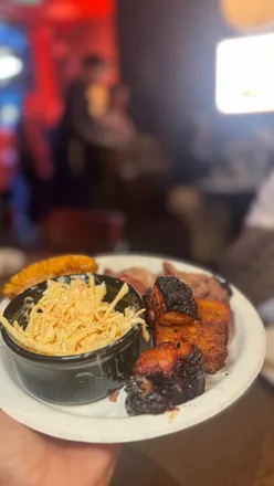 Grand opening of Spitfire BBQ on St Mary Street, Cardiff, showcasing delicious BBQ wings, brisket, and lively atmosphere.