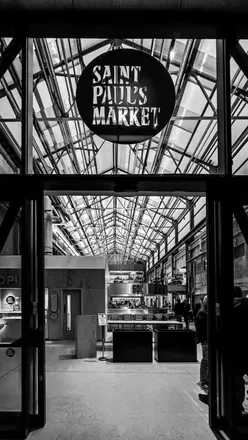 Excited diners savoring diverse dishes at the grand opening of St Paul’s Market in Birmingham.