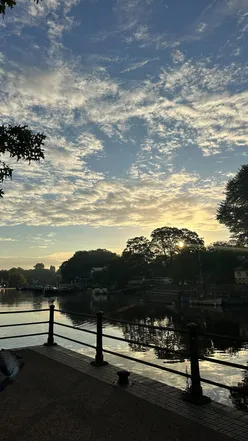 Person enjoying coffee and a book, embracing community connection and solo dates in a cozy neighborhood setting.