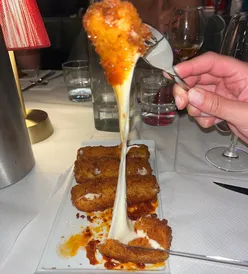 Delicious Italian-American comfort food at Grasso in Soho, featuring chicken parm and cheese-filled dishes.