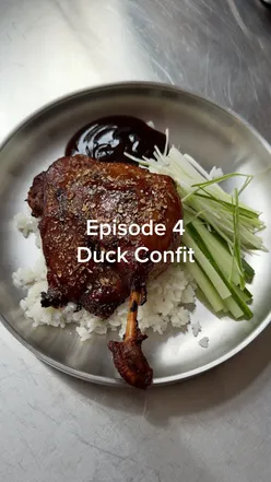 Delicious duck confit dish with hoisin sauce served with cucumbers and rice, perfect for home cooking.