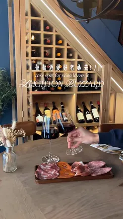 Guests enjoying red wine and a Meat Board at The Winery in Leighton Buzzard, UK, featuring cozy decor and a relaxed vibe.