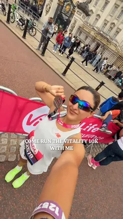 Runner celebrating at the Vitality London 10K race, showcasing New Balance gear and the vibrant atmosphere of the event.