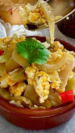 Delicious Thai-Chinese breakfast of Pak Kard Dong, stir-fried egg, and Khao Tom rice soup, perfect for comfort food lovers.