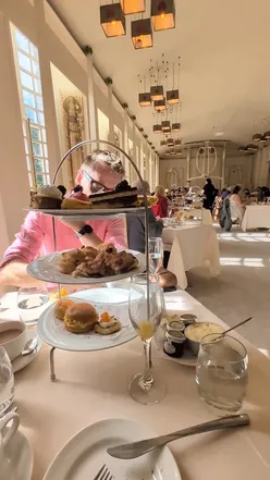 Elegant afternoon tea setup in the Music Room at House for an Art Lover, Glasgow, featuring delicious treats and live music.