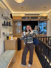 Cozy autumn outfit featuring a jumper, jeans, and UGGs, perfect for a seasonal outing.