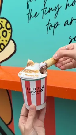 Friends enjoying luxury hot chocolate and crumpets at Fortnum & Mason in Bicester Village on a rainy autumn day.