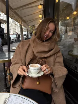Cozy autumn scene with people enjoying drinks and snacks on a Sunday in October.