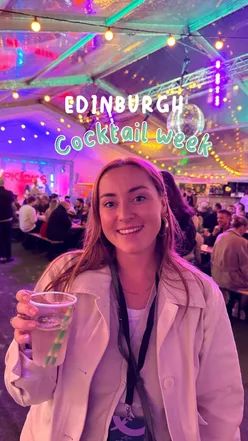 Enjoying Coconut Cooler and 0% Spicy Marg at Edinburgh Cocktail Week's launch in the vibrant Cocktail Village.
