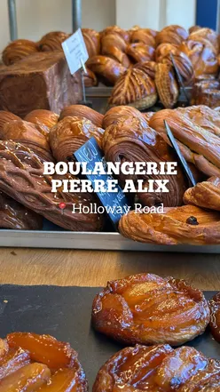 Diners enjoying sausage rolls and Pain Suisse at Boulangerie Pierre Alix in Holloway Road, London. Highly recommended!
