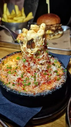 One O'Clock Gate in Dinas Powys, showcasing Asian-inspired dishes like miso burgers and mac & cheese.