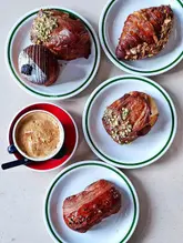Delicious pastries and brunch dishes at Populations Bakery and Boulangerie Bon Matin, highlighting their pistachio bear claw and French toast.