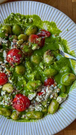 Delicious miso greens with butterbeans and tofu feta, a nutritious plant-based dish ideal for boosting iron levels.