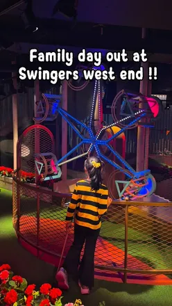 Family enjoying games, crazy golf, and delicious food at Swingers London on Oxford Street.