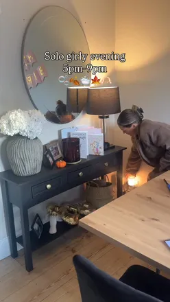 Solo girl enjoying a cozy pamper night at home with candles and snacks, perfect for a relaxing evening.