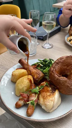 Sunday lunch at Llechwen Hall featuring pork belly, vegetarian Pivither, and sticky toffee pudding with clotted cream.