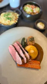 Delicious Sunday roast with katsu oysters, marmite butter, roasties, and wine at Heaneys Cardiff.