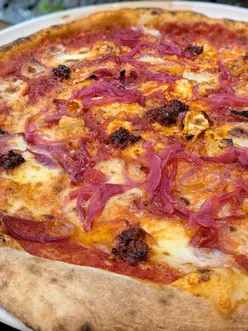Fried pizza doughballs, caprese salad, arancini, nduja pizza, and tiramisu at Calabrisella, a bustling Italian eatery in Cathays.