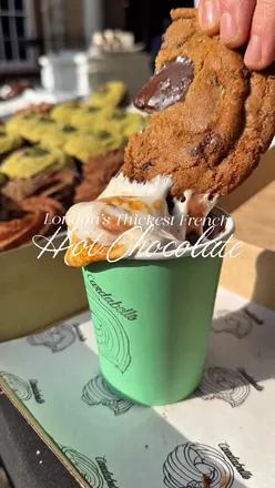 Indulgent thick hot chocolate topped with a torched marshmallow at Cardabelle in London, paired with cookies and crullers.