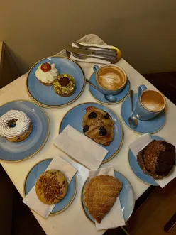 Delicious pastries at Philippe Conticini in Camden Market, including Paris-Brest and St Honoré desserts.