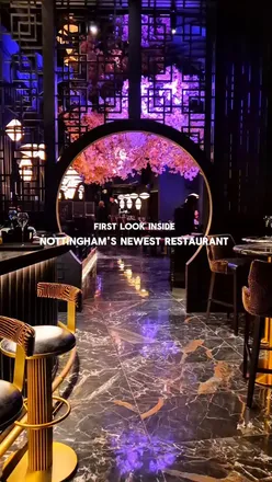 Interior of Noshi, Nottingham's new high-end Pan-Asian restaurant featuring cherry blossoms and elegant decor.