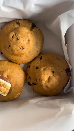 Delicious s’mores cookies from Chunk Bakery UK, featuring toasted marshmallow and chocolate center, alongside chocolate chip cookies.