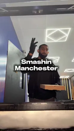 Excited diners enjoying 50% off burgers at Smashin MCR in Manchester, showcasing delicious halal options.