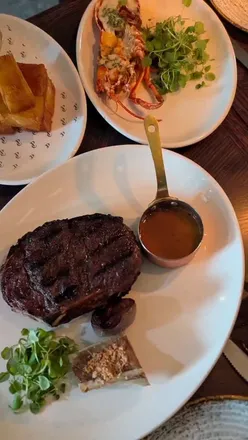 Enjoying autumn dishes at Pearly Cow Brighton, featuring scallops, steak, and indulgent desserts by the seafront.