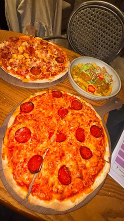 Enjoying pizza and loaded fries at YOLO Townhouse in Newcastle, featuring great cocktails and weekly offers.